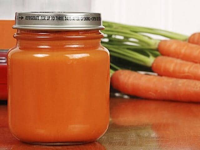 Homemade Baby Food in a jar with fresh carrots in background