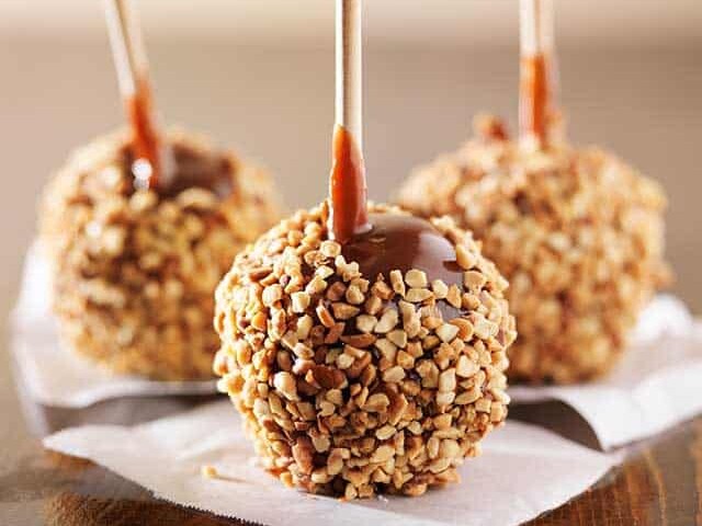 Three carmel apples with nuts