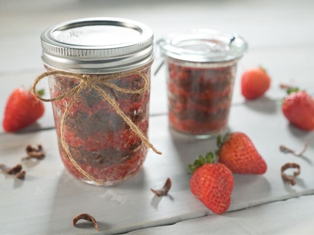 Two Jars of DIY Sugar Scrub with whole strawberries on the side