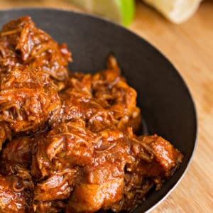 glazed shredded beef in a dark-colored bowl