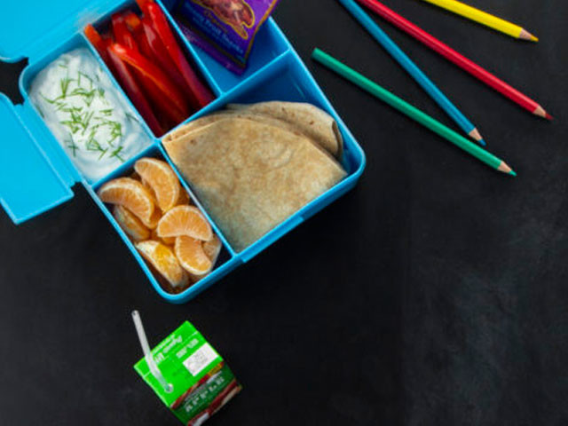 Lunch box, juice and colored pencils