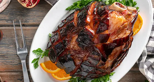 Maple glazed ham on a serving plate