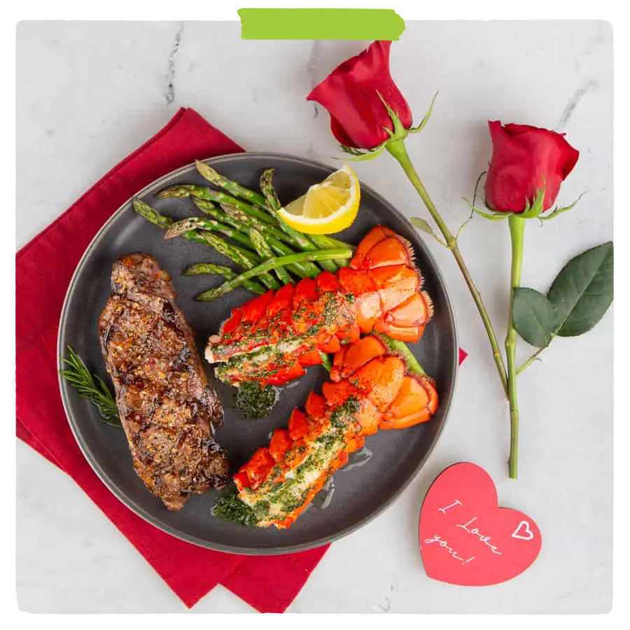 Steak and lobster tails on a plate