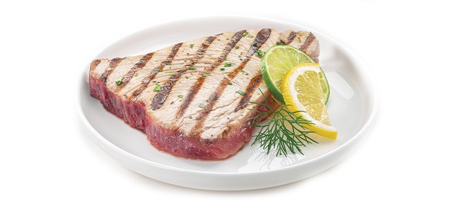 cooked tuna on a plate with lemon