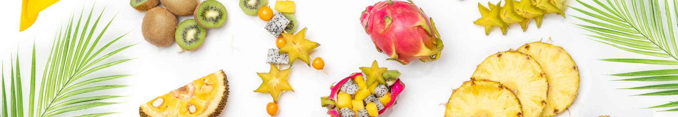 tropical fruits surrounded by palm leaves