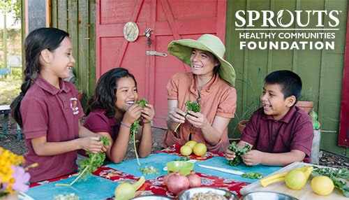 Sprouts Foundation logo next to teacher with students