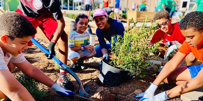 kids and teacher working in garden