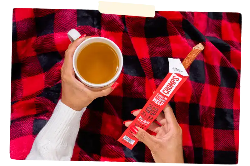 Hand holding a Chomps meat stick